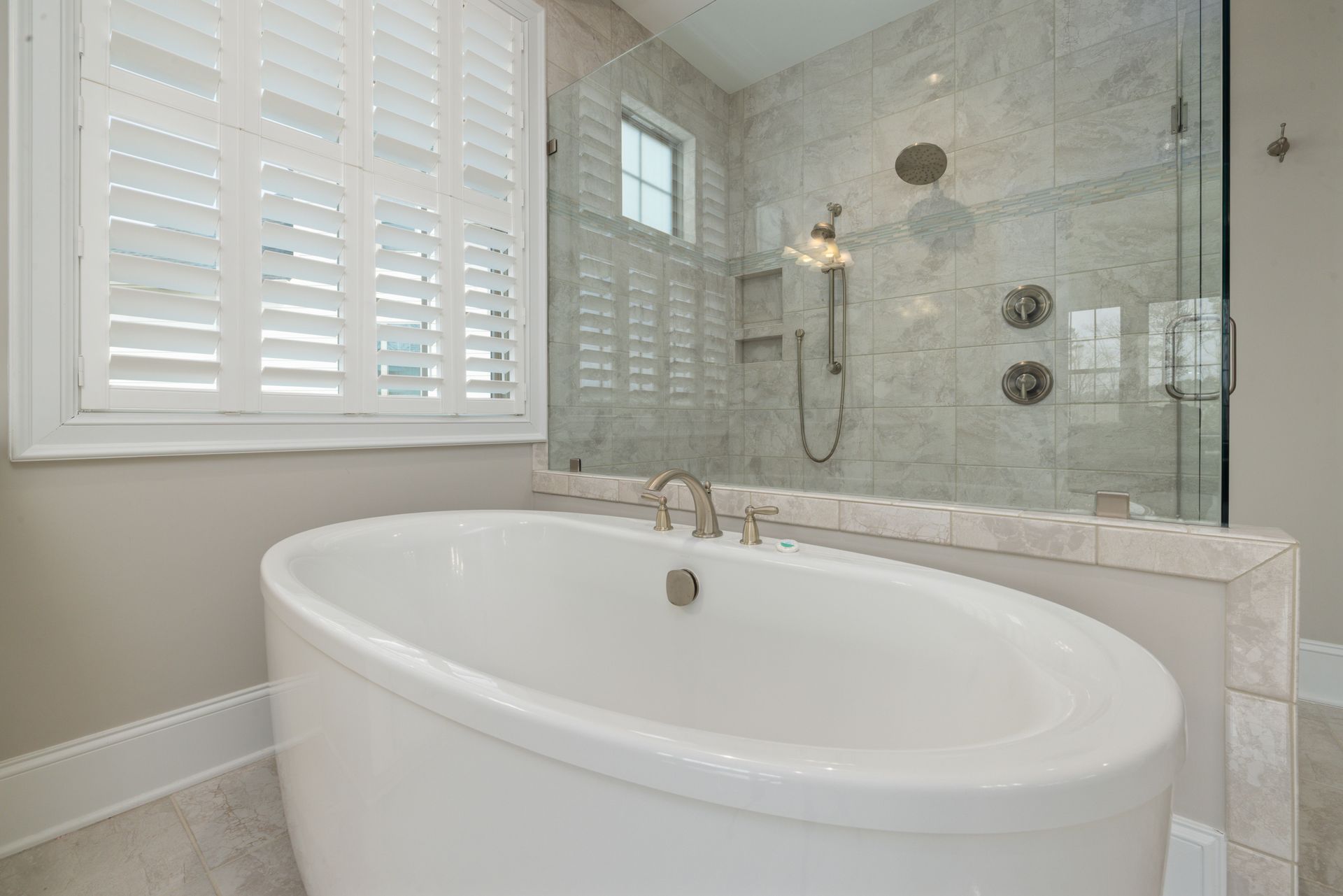 Modern bathroom featuring a luxurious freestanding tub and glass shower, ideal for home design inspiration.